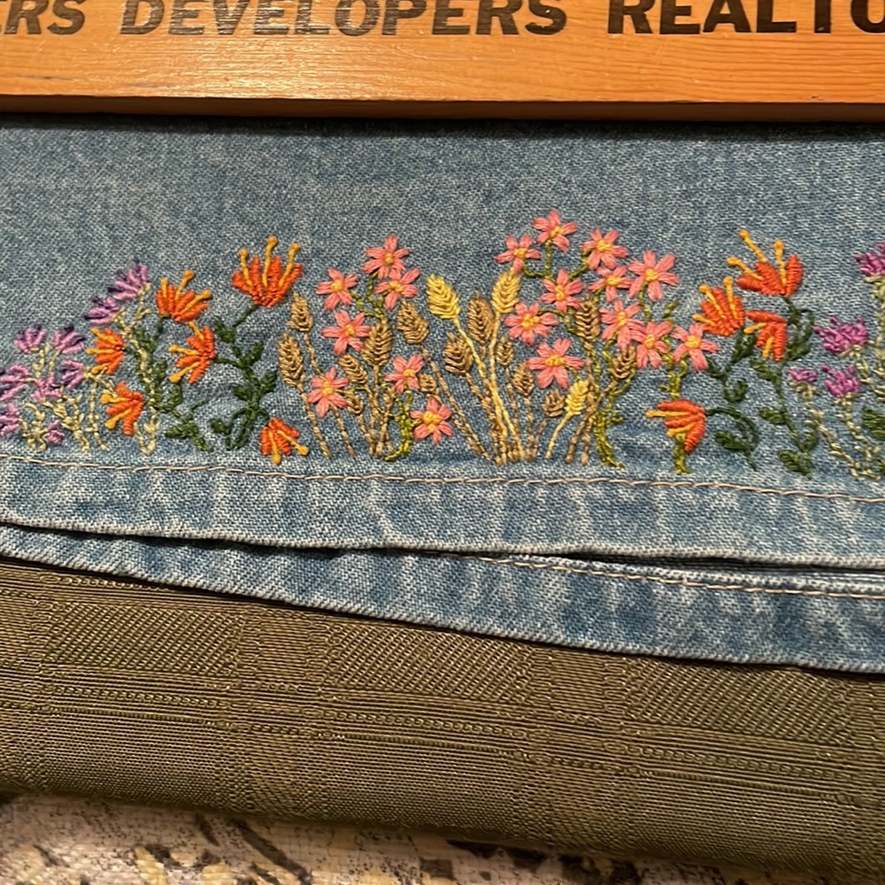 Denim skirt, buttons in the front, elastic back waist band and hand embroidery.